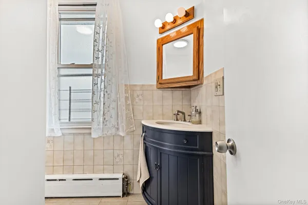 a bathroom with a sink vanity and a mirror