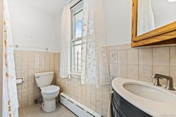 a bathroom with a toilet sink and shower