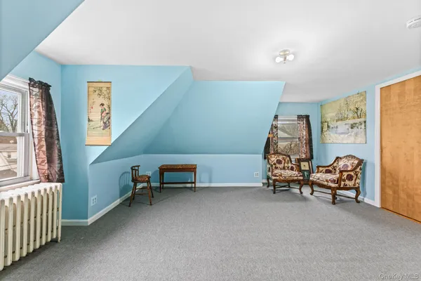 a bedroom with furniture and a window