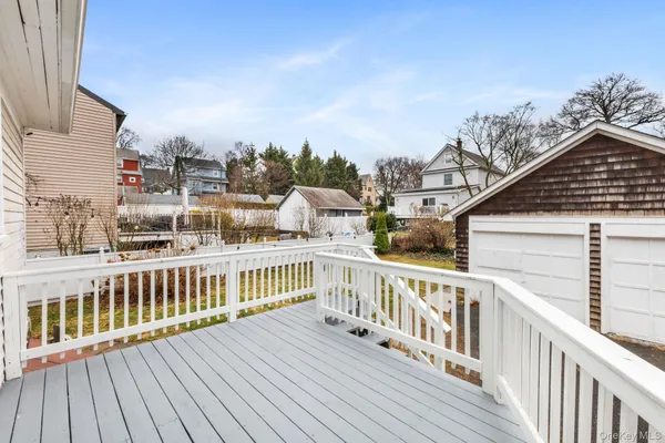 a view of a balcony with wooden floor and fence