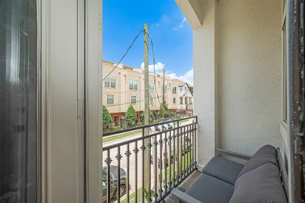 a view of a balcony with furniture