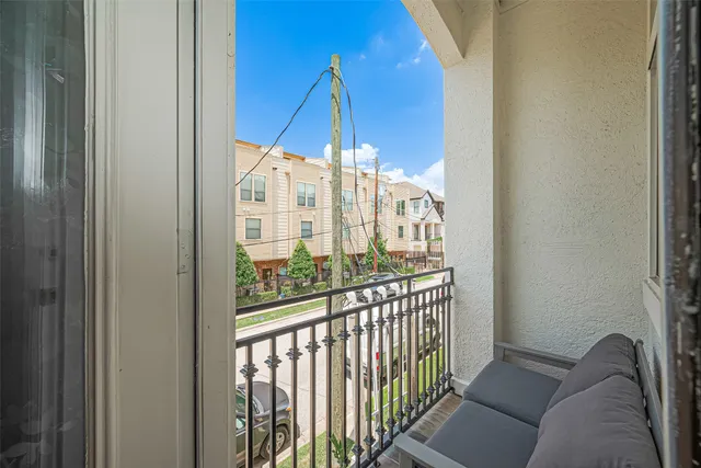a view of a balcony with furniture