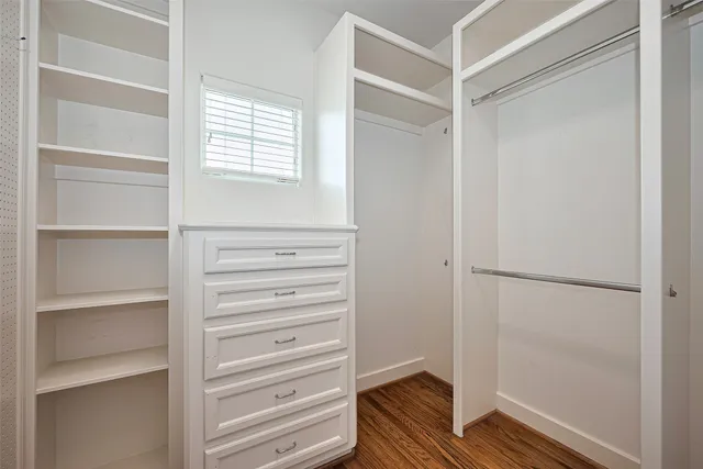 a view of walk in closet with empty racks