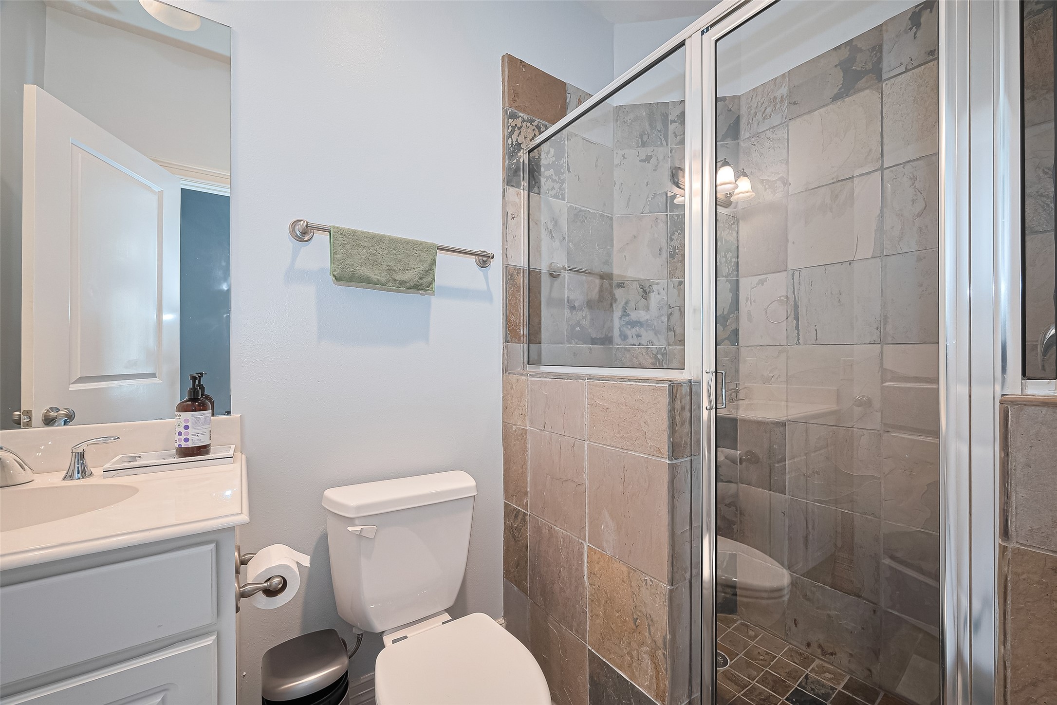 3925 Floyd Street Houston, TX 77007 - Photo 7 of 24 a bathroom with a toilet sink vanity and shower