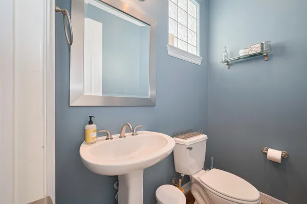 a bathroom with a sink a toilet and mirror