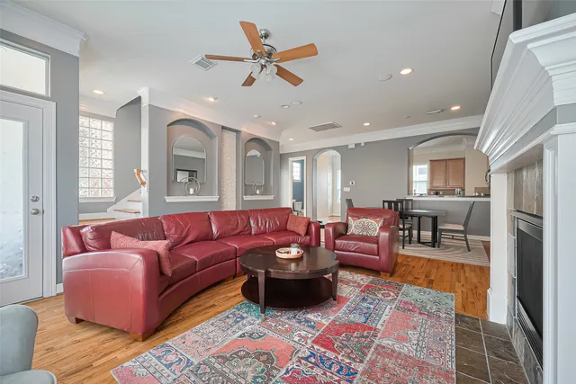 a living room with furniture ceiling fan and a rug