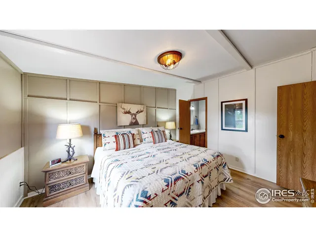 a bedroom with two beds and a chandelier