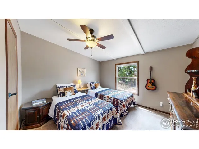 a bedroom with two beds and a window