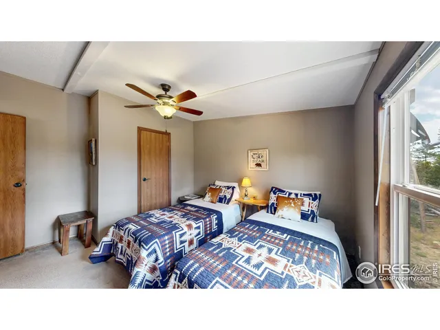 a bedroom with two beds and a chandelier