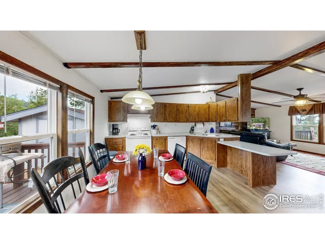 a kitchen with stainless steel appliances kitchen island granite countertop a table and chairs in it