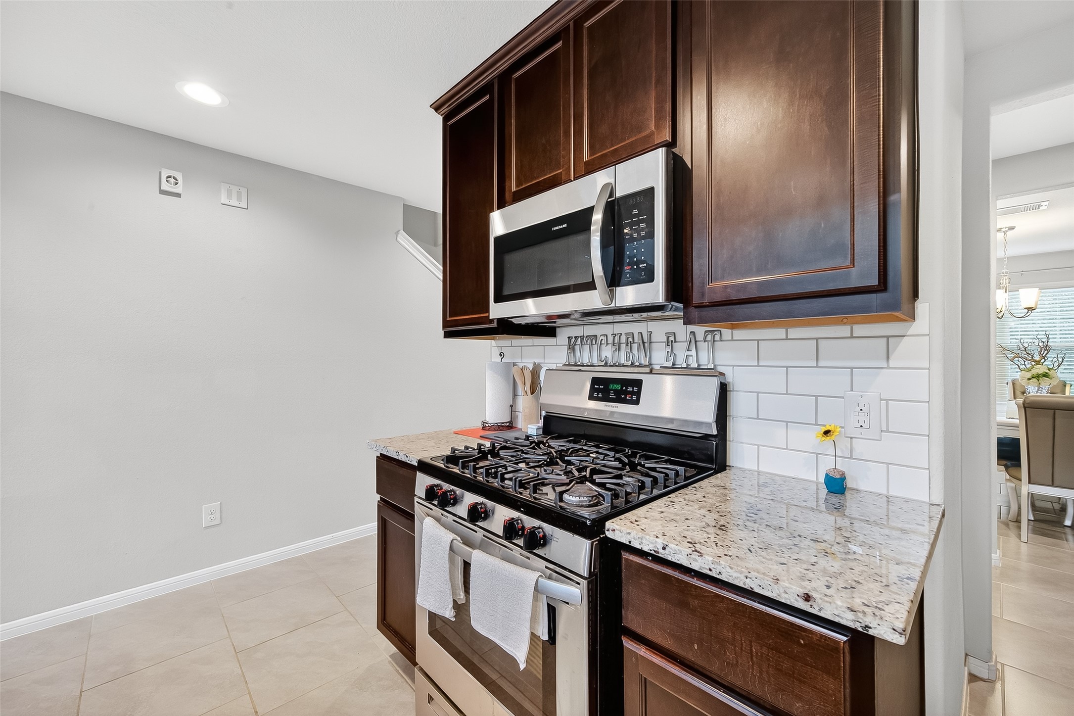 8007 Carillon Way Rosharon, TX 77583 - Photo 12 of 33 a kitchen with stainless steel appliances granite countertop a stove and a microwave