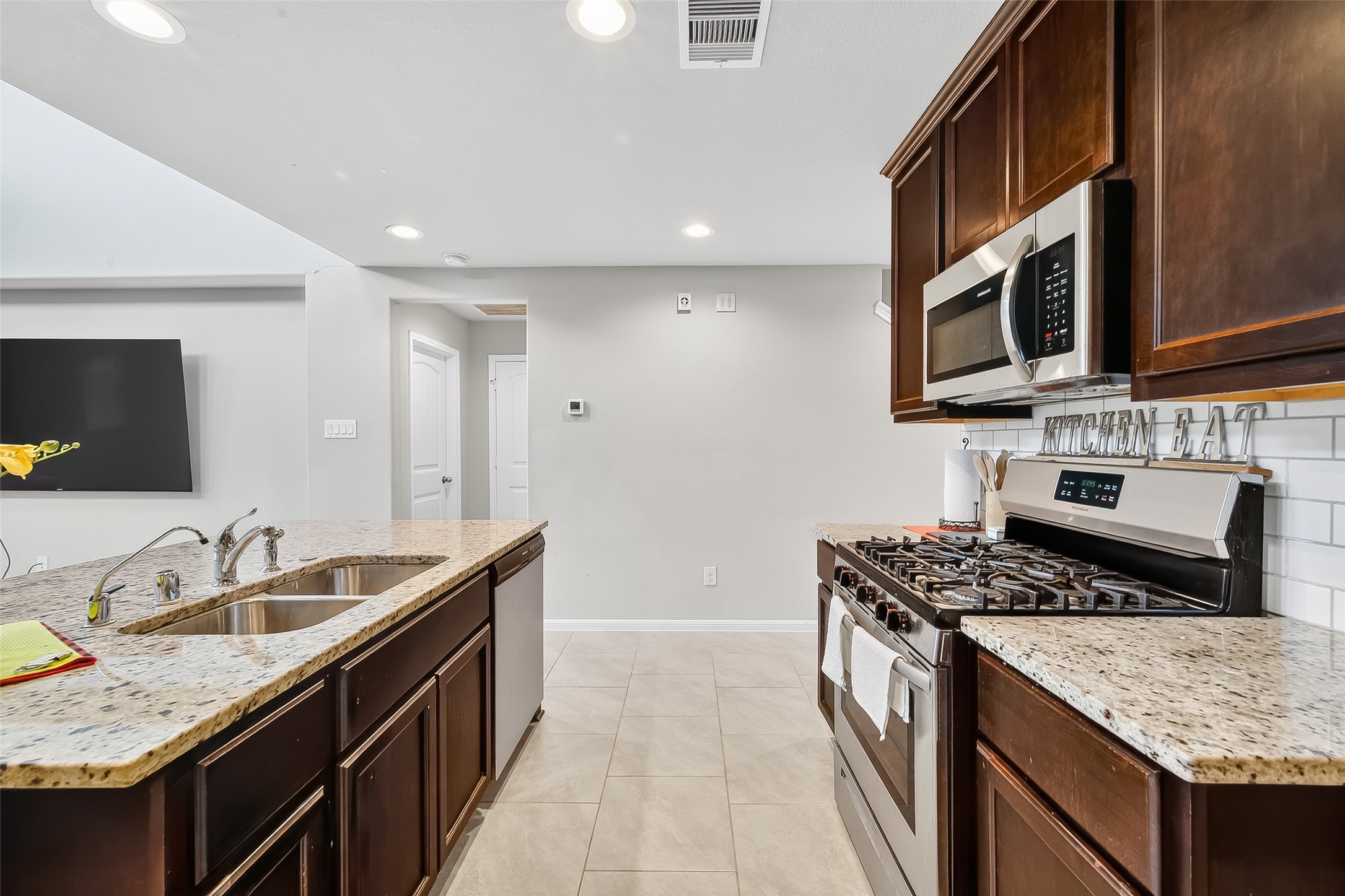 8007 Carillon Way Rosharon, TX 77583 - Photo 13 of 33 a kitchen with stainless steel appliances granite countertop a sink stove and refrigerator
