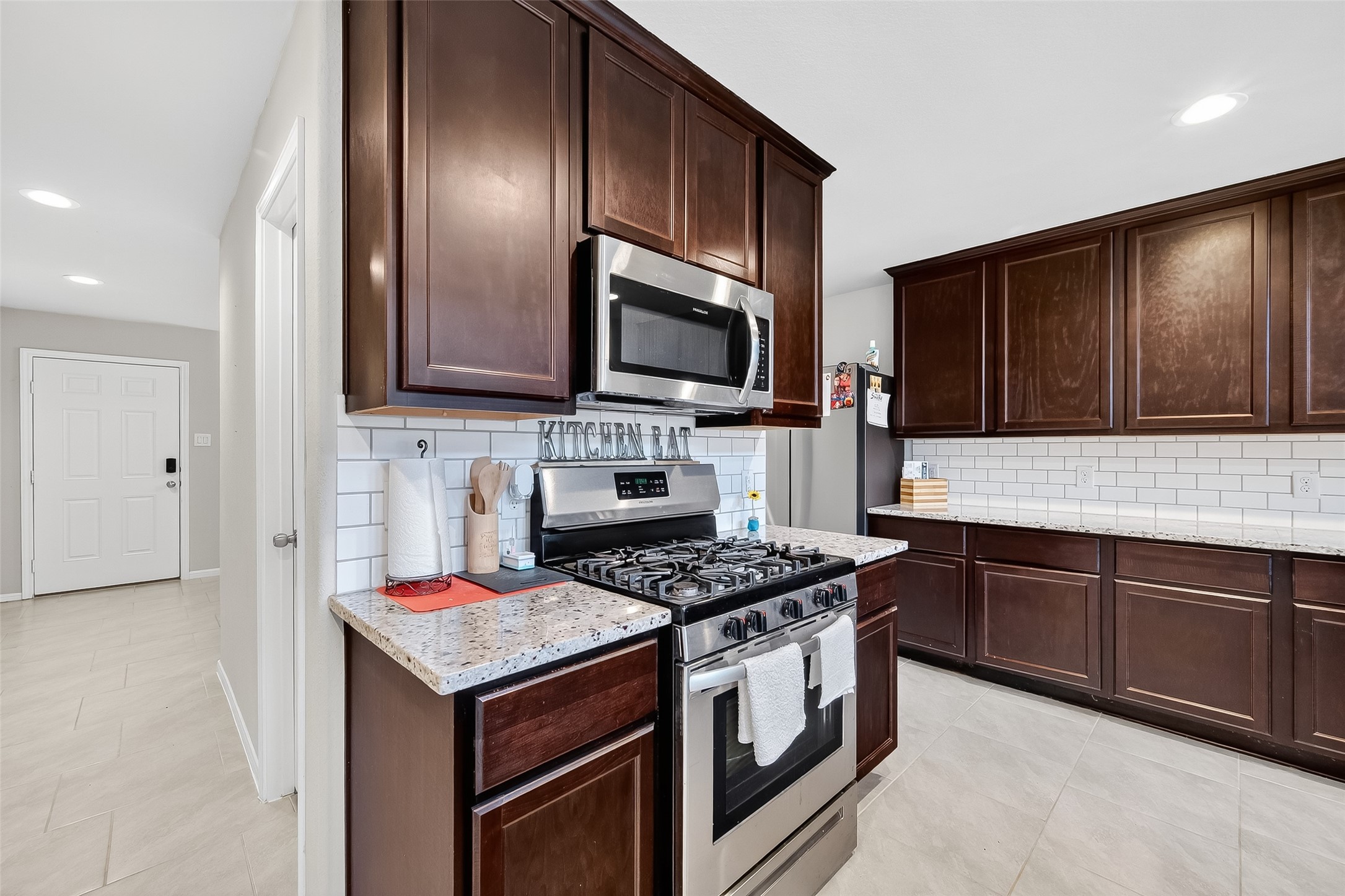 8007 Carillon Way Rosharon, TX 77583 - Photo 10 of 33 a kitchen with granite countertop stainless steel appliances and cabinets