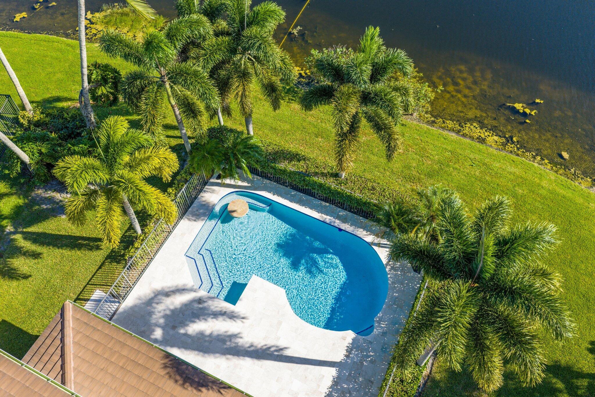 19245 Skyridge Circle Boca Raton, FL 33498 - Photo 61 of 70 a view of a swimming pool with a yard