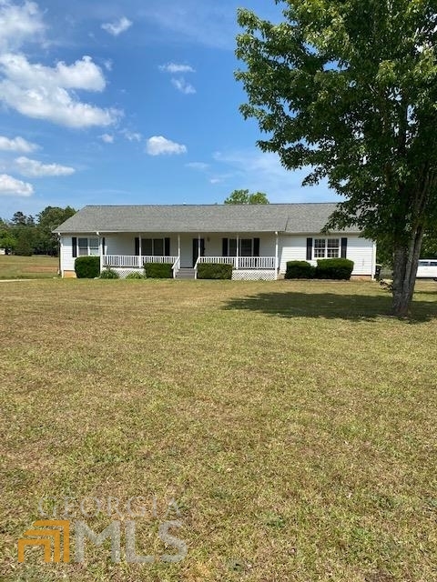 2237 South Ola Road Locust Grove, GA 30248 - Photo 1 of 1 a front view of house with yard and trees