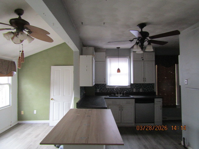 2334 18th Avenue Moline, IL 61265 - Photo 9 of 49 a kitchen with kitchen island stainless steel appliances a table and a refrigerator