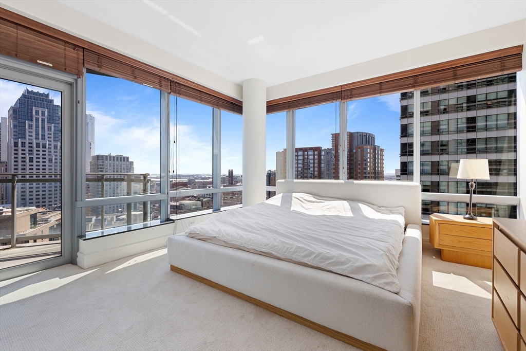 1 Avery Street, Unit 23C Boston, MA 02111 - Photo 15 of 22 a large bedroom with a large bed and large windows
