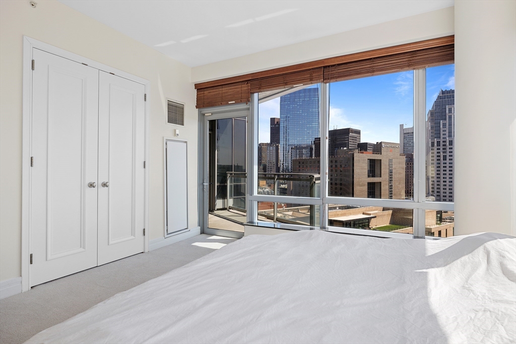 1 Avery Street, Unit 23C Boston, MA 02111 - Photo 16 of 22 a view of a livingroom with furniture and floor to ceiling window