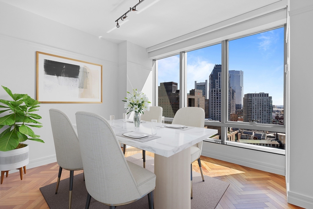 1 Avery Street, Unit 23C Boston, MA 02111 - Photo 6 of 22 a dining room with furniture and wooden floor