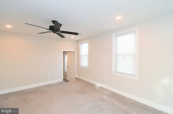 a view of a livingroom with a window and a ceiling fan