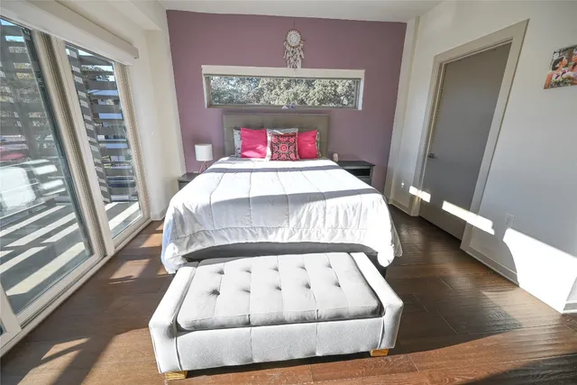 a bed sitting in a bedroom next to a window