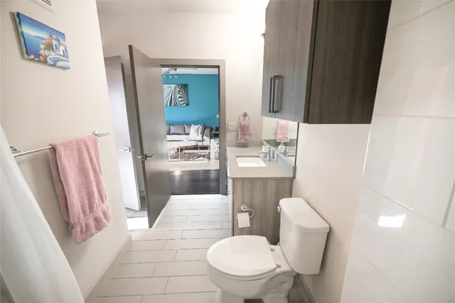 a white toilet sitting next to a bathroom sink