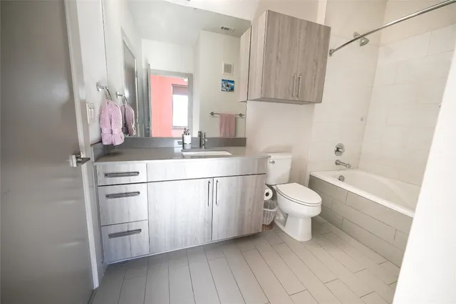 a bathroom with a sink a toilet and bathtub