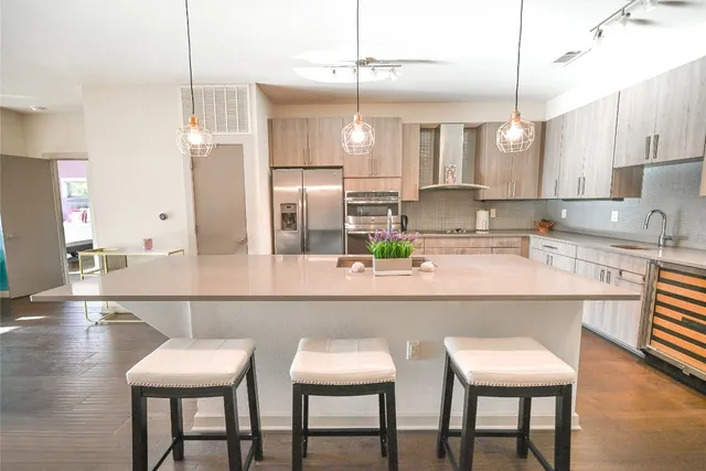 a kitchen with stainless steel appliances a sink and cabinets