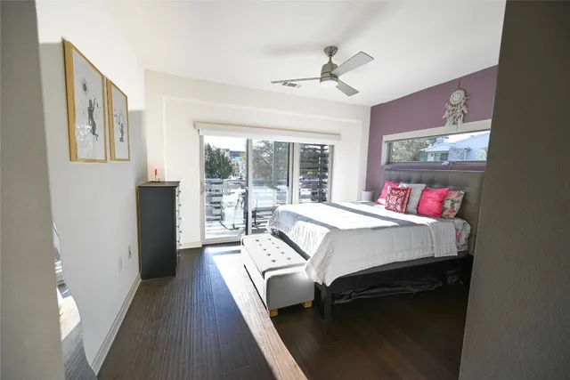 a bed room with a bed and a large window