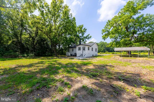 a swimming pool with outdoor seating and yard