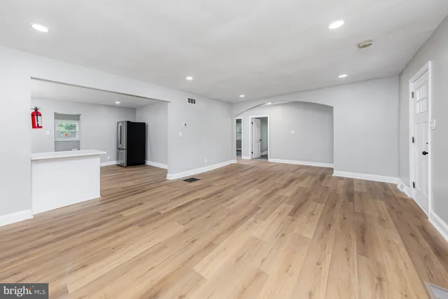 a view of an empty room and wooden floor