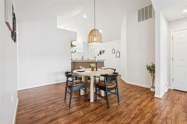 a view of a dining room with furniture and wooden floor