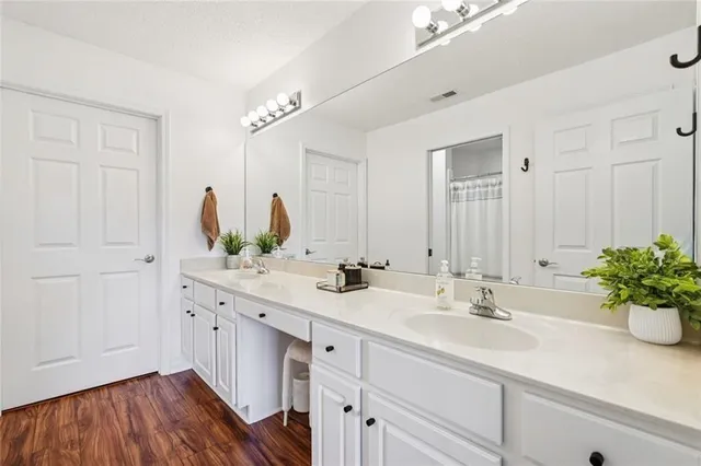 a bathroom with a sink double vanity and a mirror