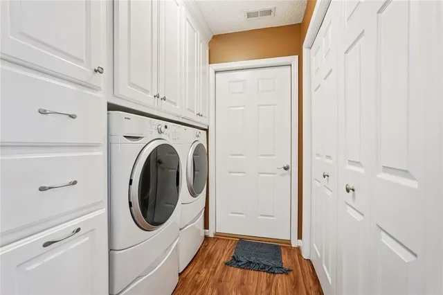 a view of a storage and utility room with washer and dryer