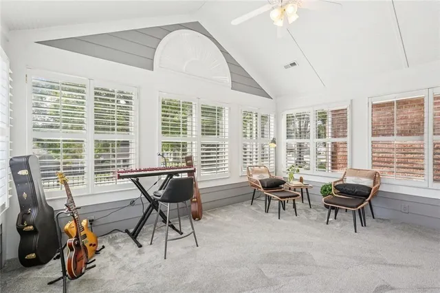 a living room with furniture and floor to ceiling windows