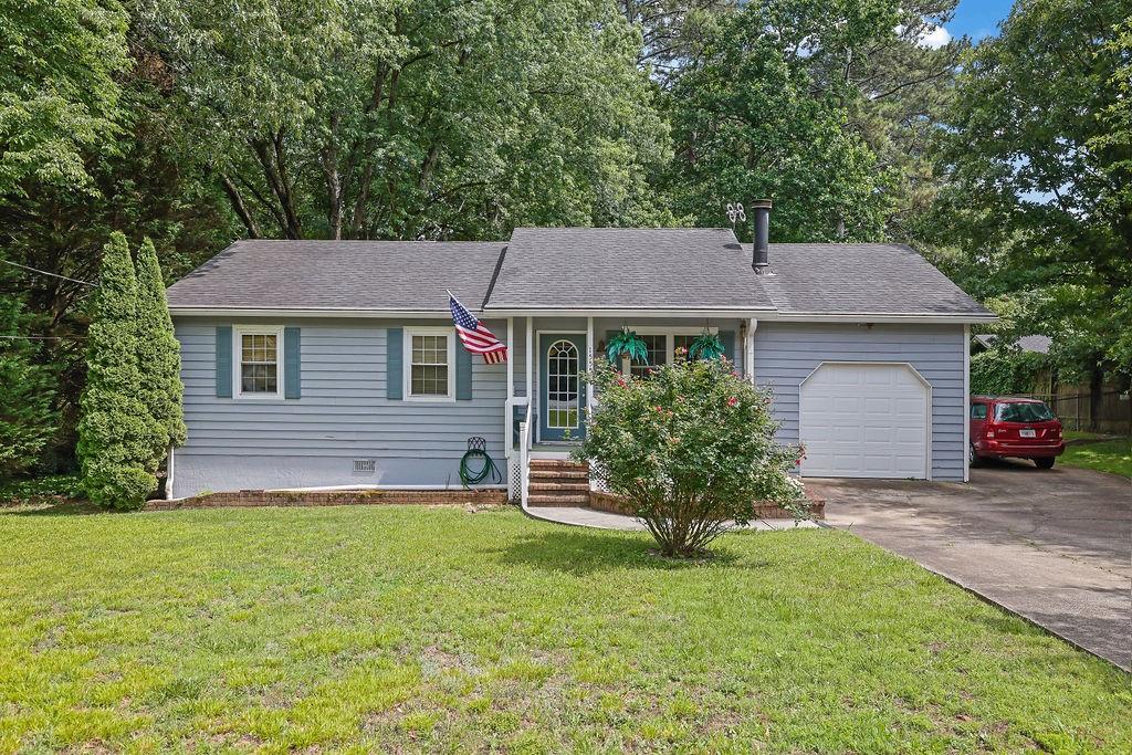 1555 Rock Springs Road Buford, GA 30519 - Photo 1 of 27 a front view of a house with a garden and yard