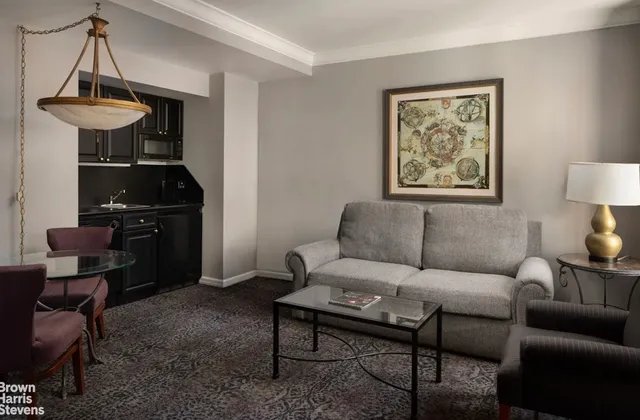 a living room with furniture a rug and a window