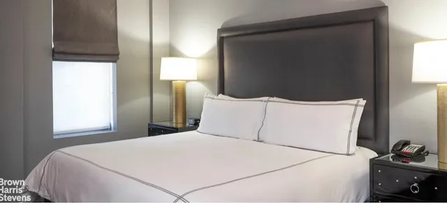 a bed room with a bed and a tv