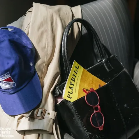 a living room with patio furniture and a chandelier