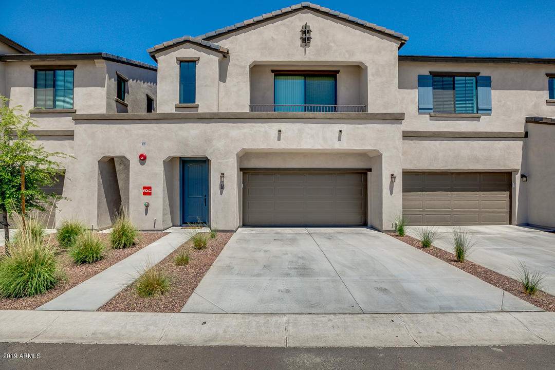 3900 East Baseline Road, Unit 114 Phoenix, AZ 85042 - Photo 1 of 31 a front view of a house with a yard and garage