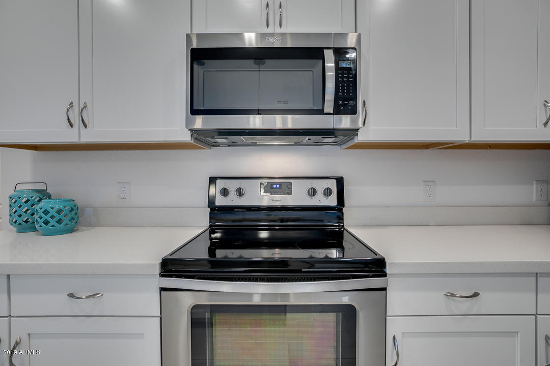 3900 East Baseline Road, Unit 114 Phoenix, AZ 85042 - Photo 11 of 31 a stove top oven sitting inside of a kitchen