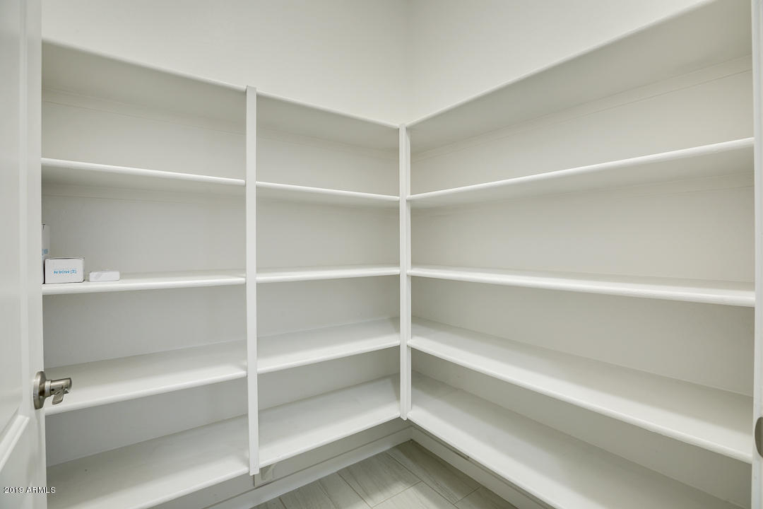 3900 East Baseline Road, Unit 114 Phoenix, AZ 85042 - Photo 12 of 31 a view of walk in closet with empty racks