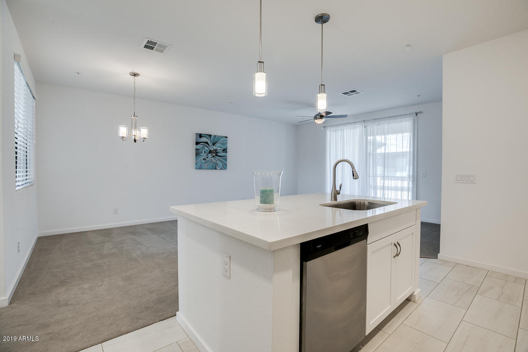 3900 East Baseline Road, Unit 114 Phoenix, AZ 85042 - Photo 13 of 31 a kitchen with a sink and a refrigerator