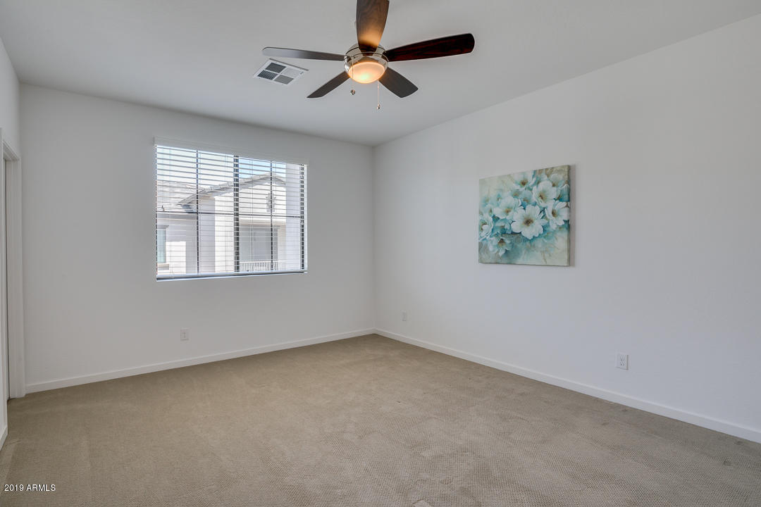 3900 East Baseline Road, Unit 114 Phoenix, AZ 85042 - Photo 14 of 31 an empty room with windows and fan