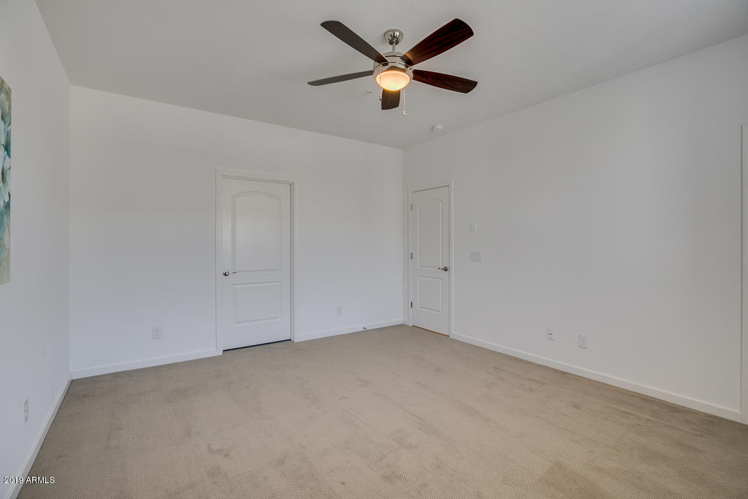 3900 East Baseline Road, Unit 114 Phoenix, AZ 85042 - Photo 16 of 31 an empty room with a ceiling fan and window