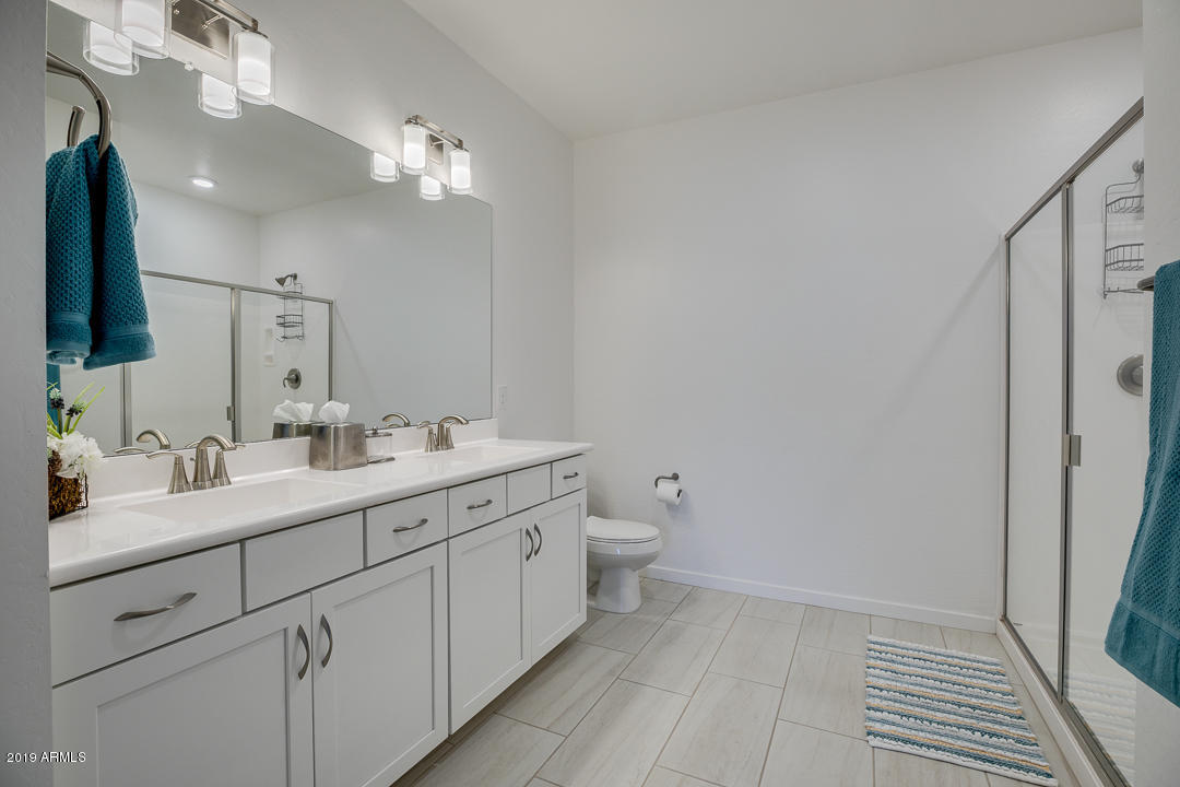 3900 East Baseline Road, Unit 114 Phoenix, AZ 85042 - Photo 20 of 31 a bathroom with a double vanity sink and mirror