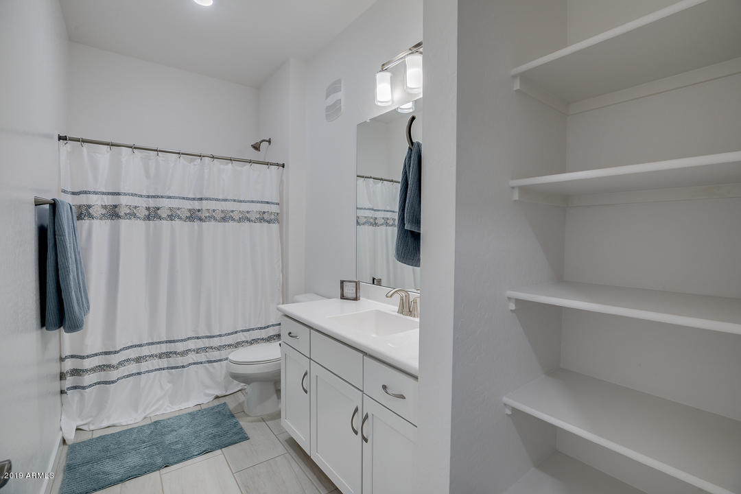 3900 East Baseline Road, Unit 114 Phoenix, AZ 85042 - Photo 24 of 31 a bathroom with a sink a toilet and shower
