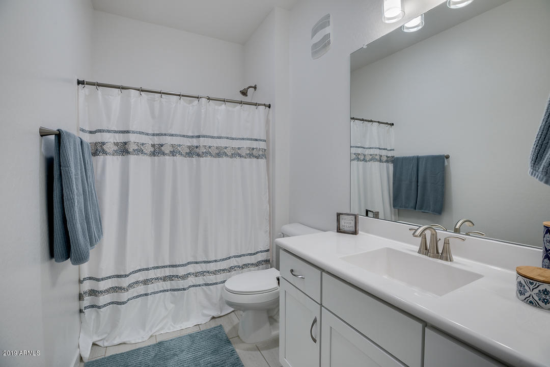 3900 East Baseline Road, Unit 114 Phoenix, AZ 85042 - Photo 25 of 31 a bathroom with a granite countertop sink and a mirror