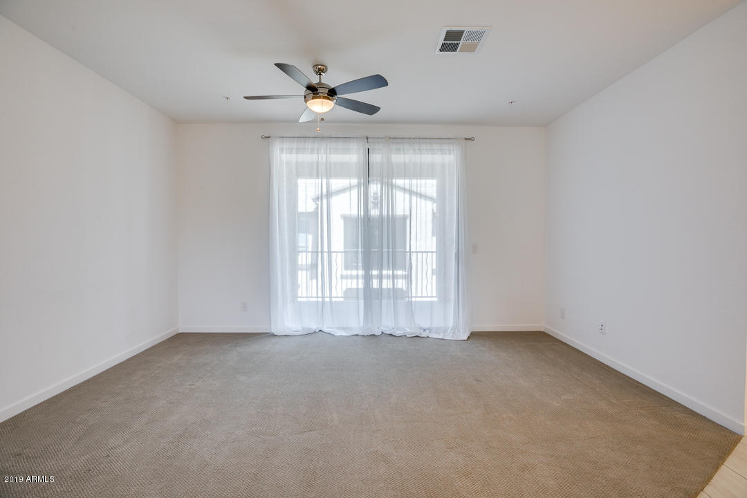 3900 East Baseline Road, Unit 114 Phoenix, AZ 85042 - Photo 6 of 31 a view of an empty room with a window