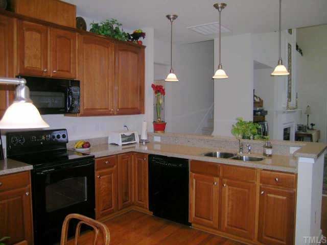 3405 Parlor Street Raleigh, NC 27614 - Photo 4 of 10 a kitchen with granite countertop a sink stainless steel appliances and cabinets